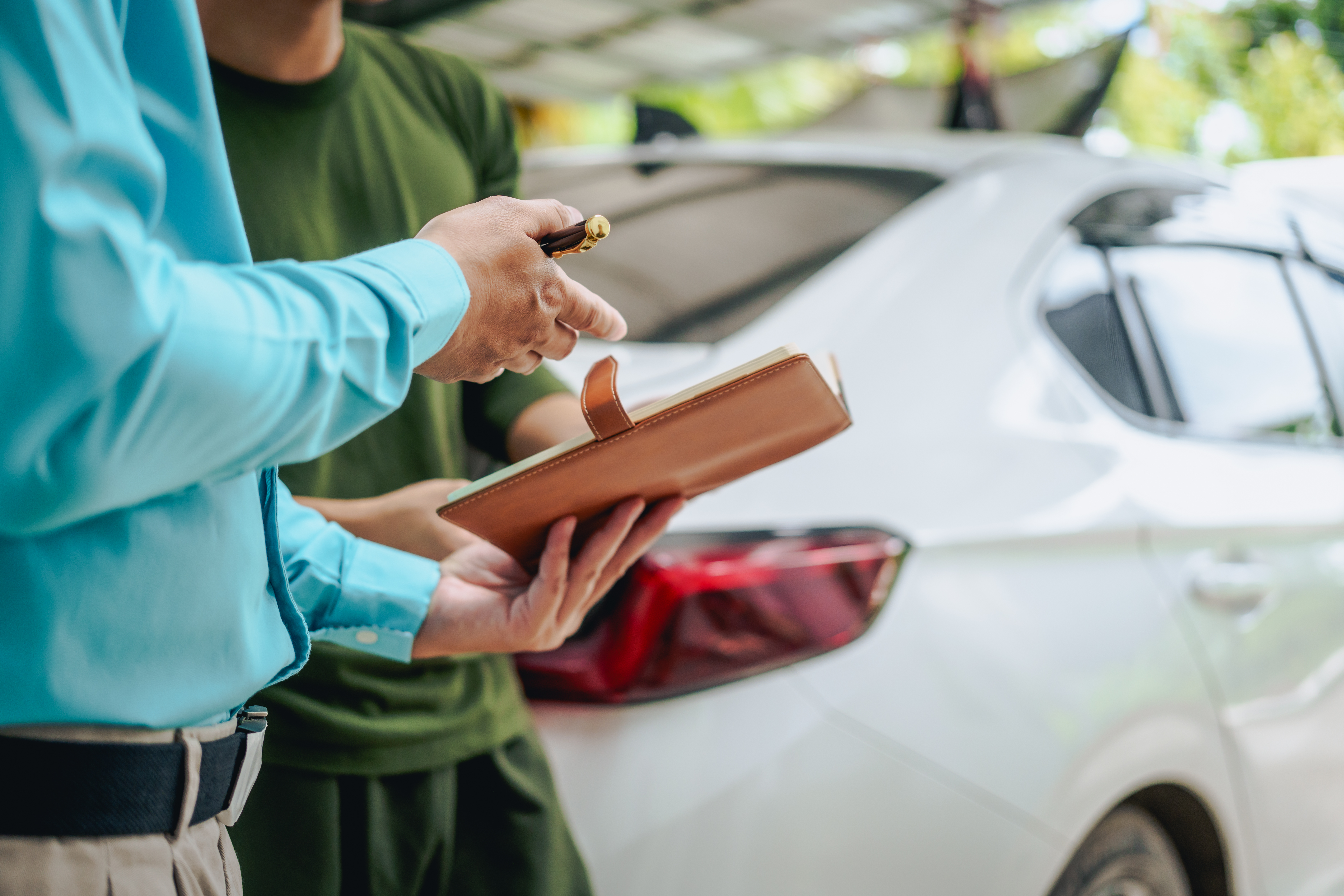 A closeup of a man explaining a jdm car appraisal to another man.
