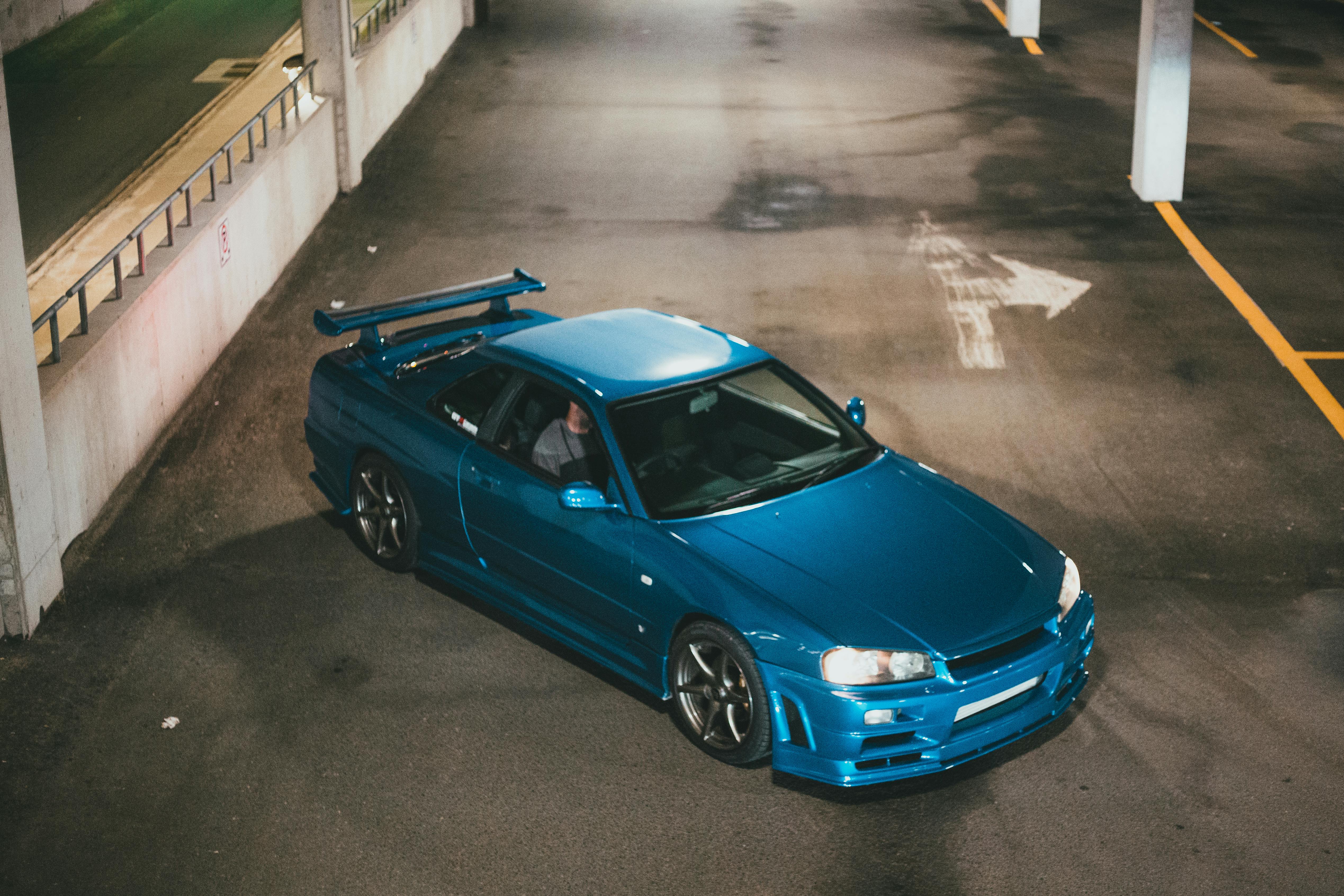 A teal Nissan Skyline GTR - a JDM car imported to Canada.