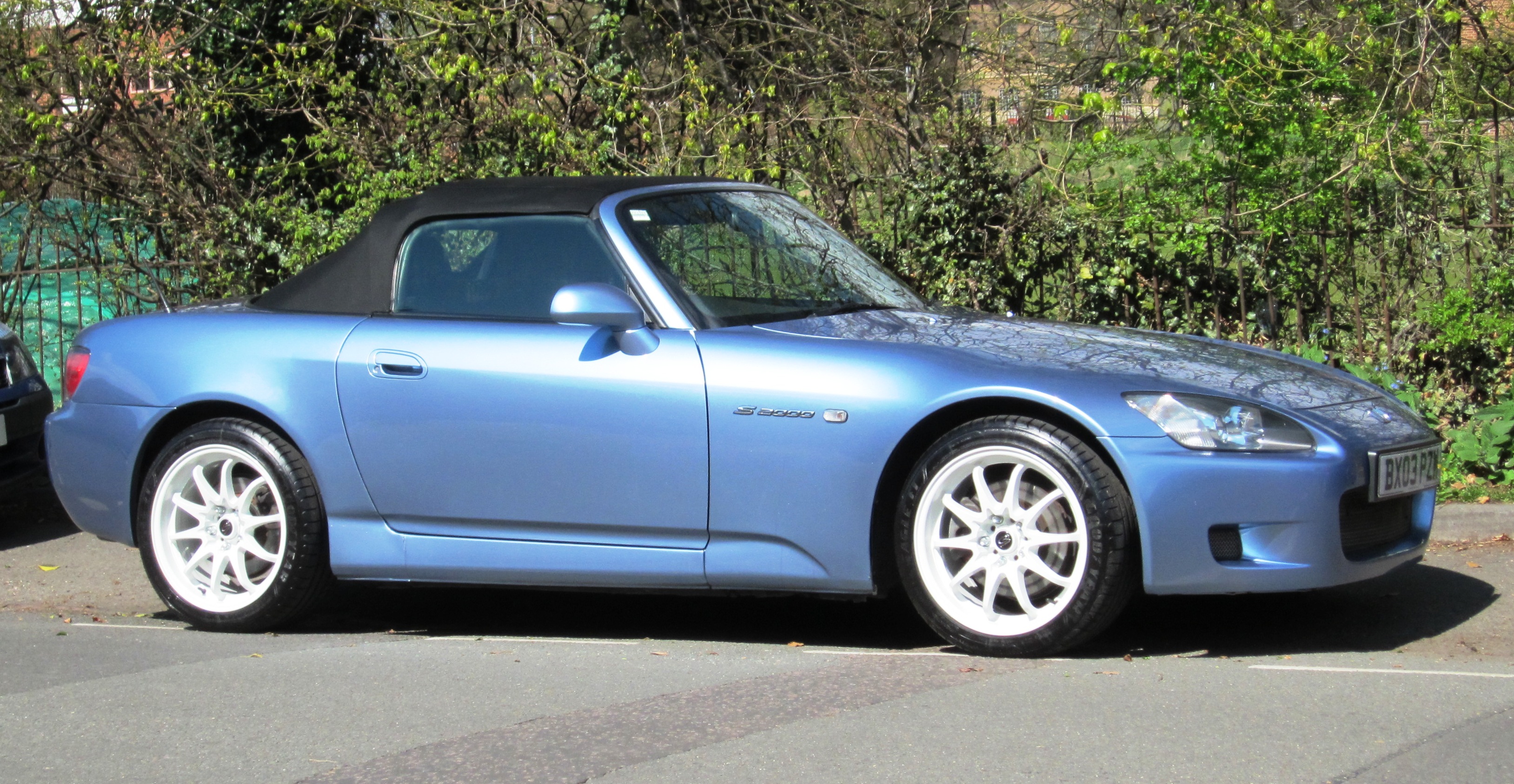 A blue Honda S2000. This is a JDM car that can be imported into the USA and Quebec in 2025.