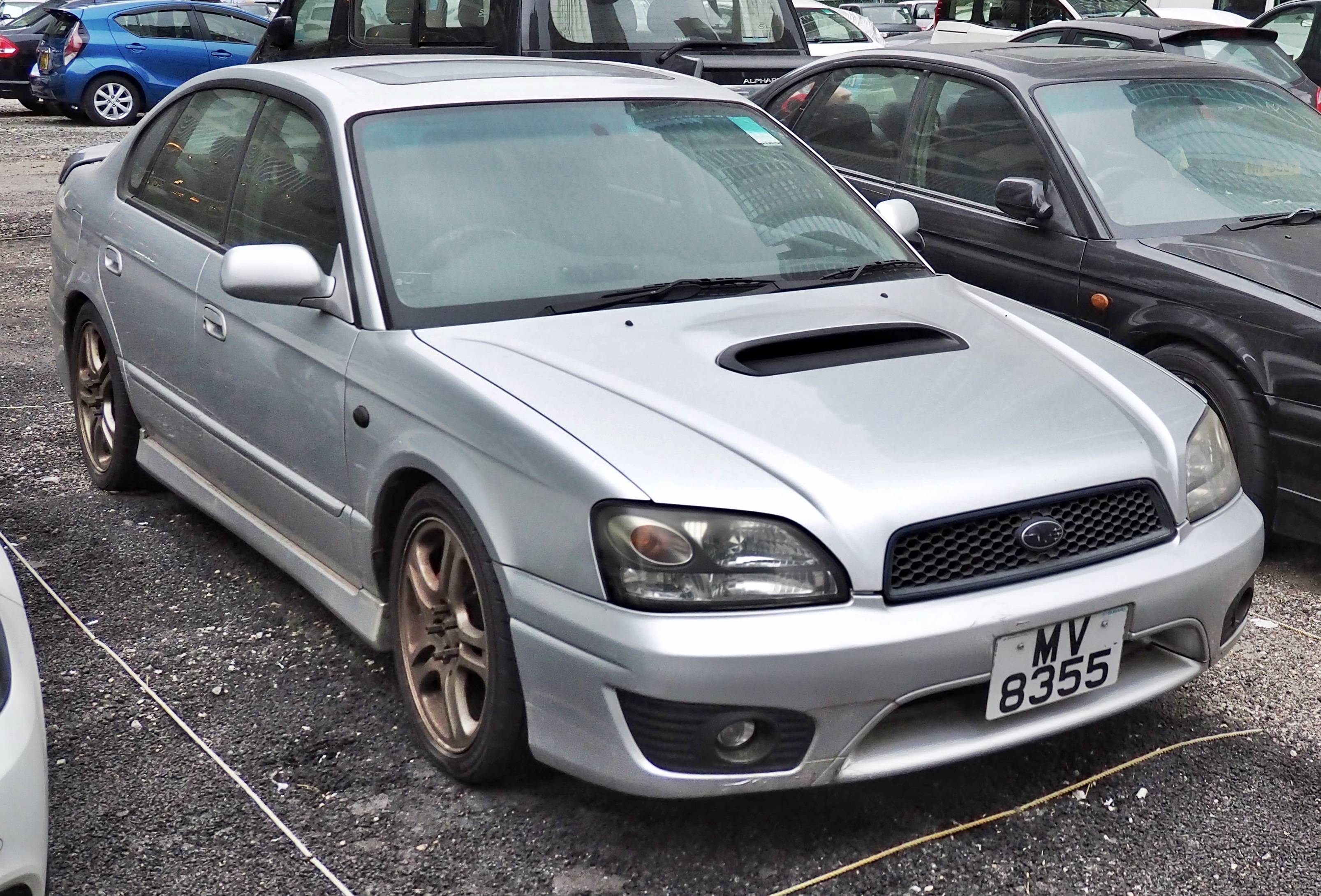 A Subaru Legacy B4 RSK in a parking lot full of vehicles. This is a JDM car that can be imported into the USA and Quebec in 2025.