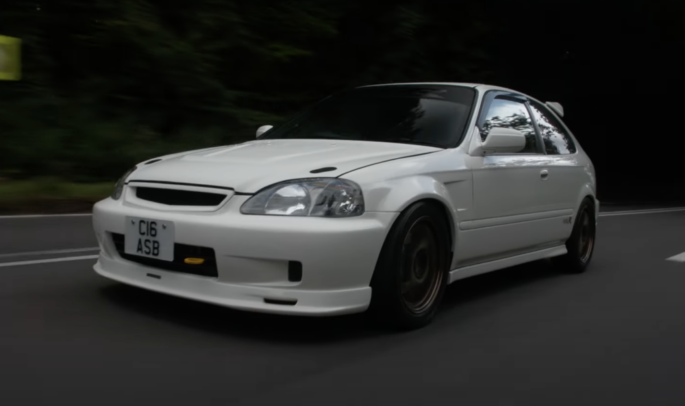 A white Honda Civic Type R speeding down an empty highway. This is a JDM car that can be imported in the USA and Quebec in 2024.