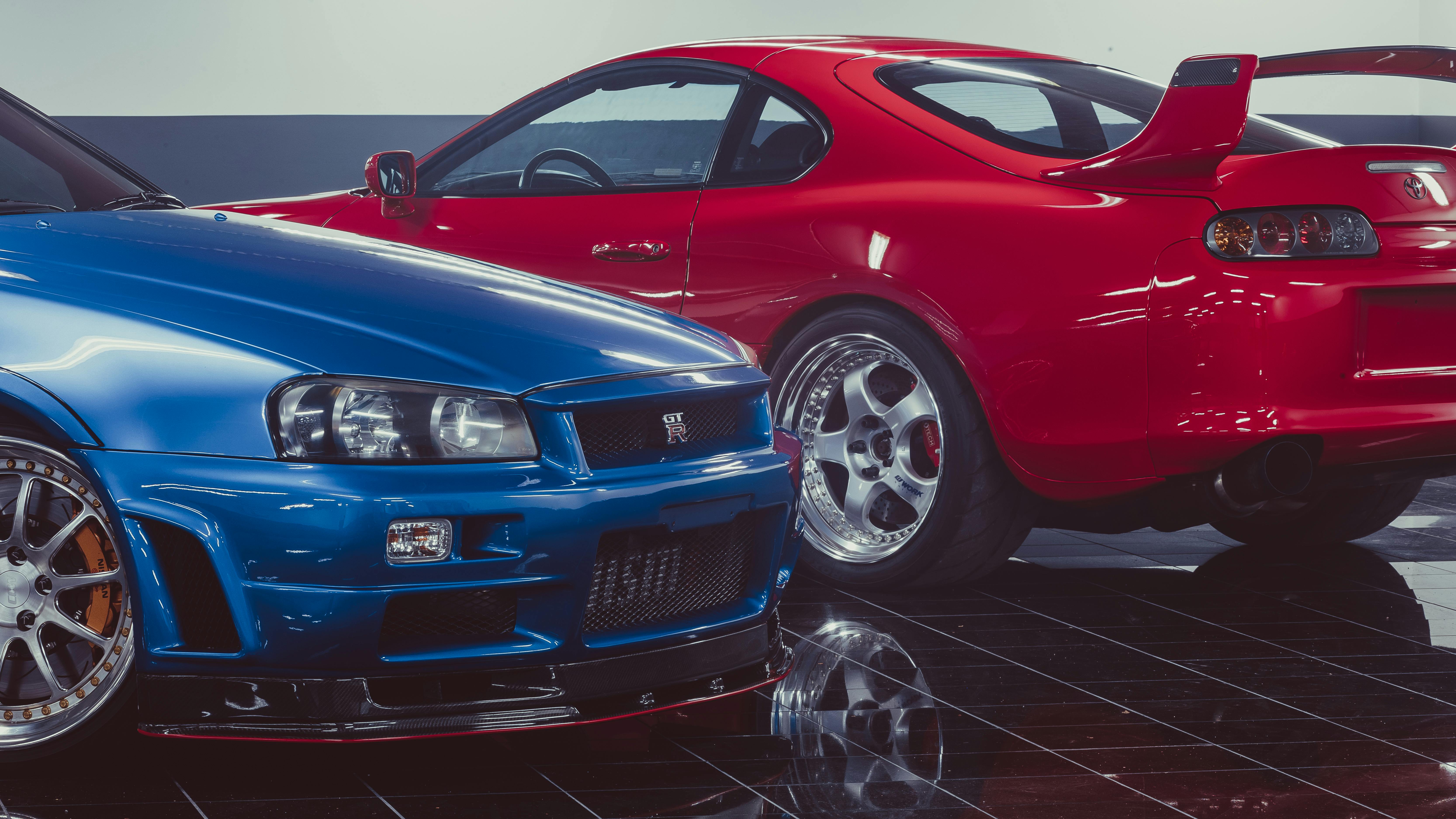 A blue and red Nissan Skyline GTR jdm car in a showroom.